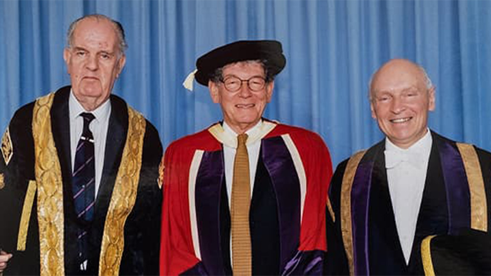 3 men in university gowns