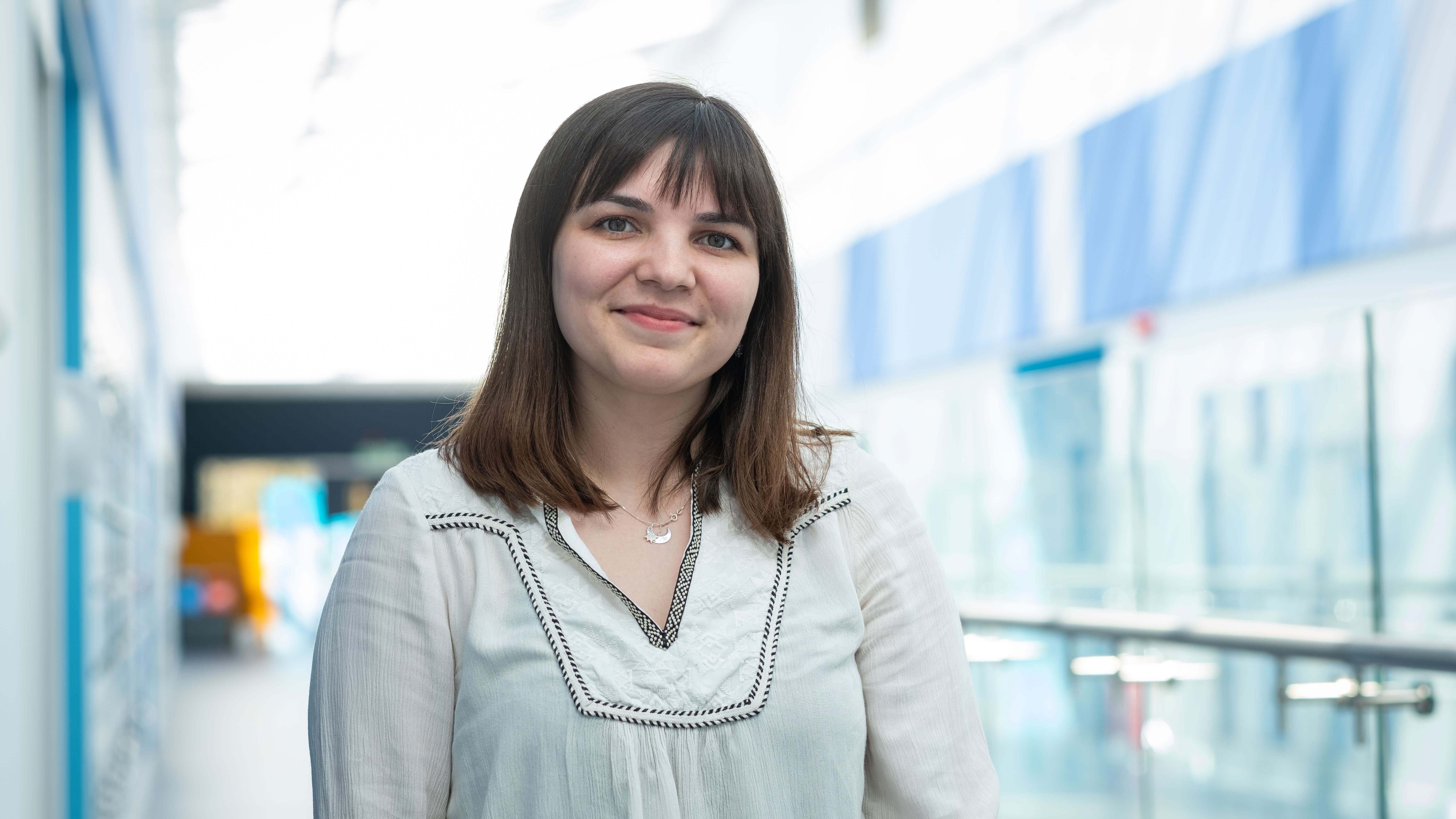 Master's student Melis in the corridor of the STEMLab facility