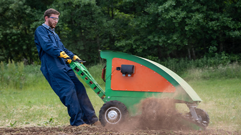 Man on field using machine