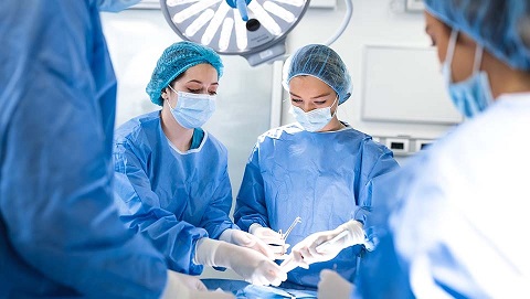 A picture of a group of surgeons performing surgery.