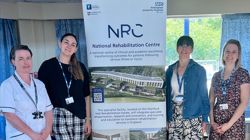 Staff involved in rehabilitation research at Linden Lodge are standing next to a promotional banner for the National Rehabilitation Centre