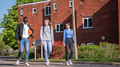 Three students walking past Falkner Eggington Hall.