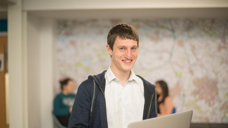 Anthony stood infront of a world map