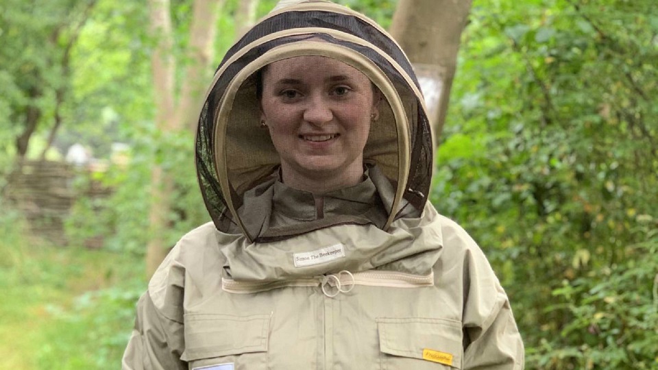 A student outside wearing protective clothing.