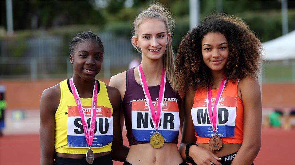 Three young athletes wearing their medals