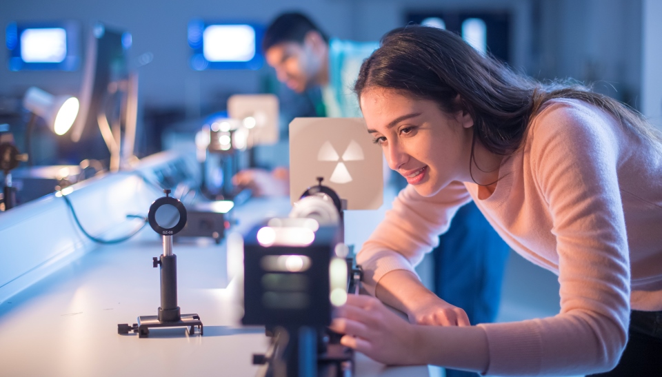 A student sets up an optics experiment