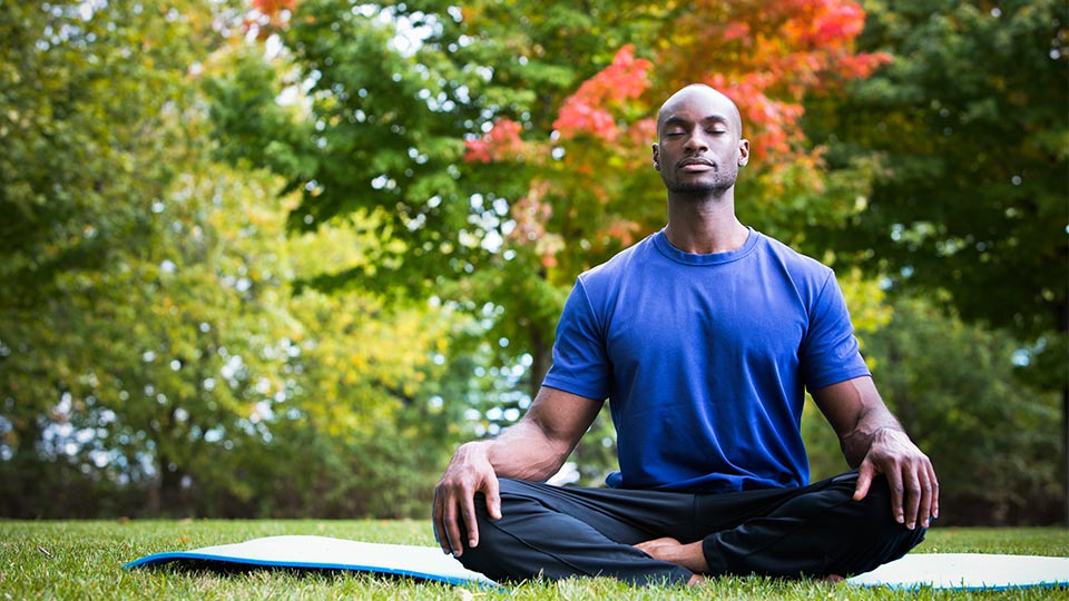 Pictured is a man meditating. 