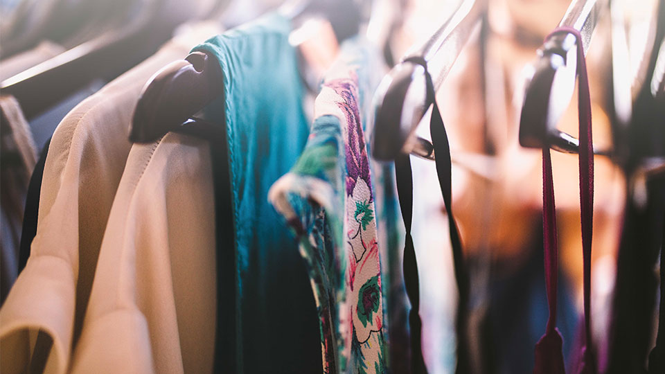 Second hand clothing on a rail. 