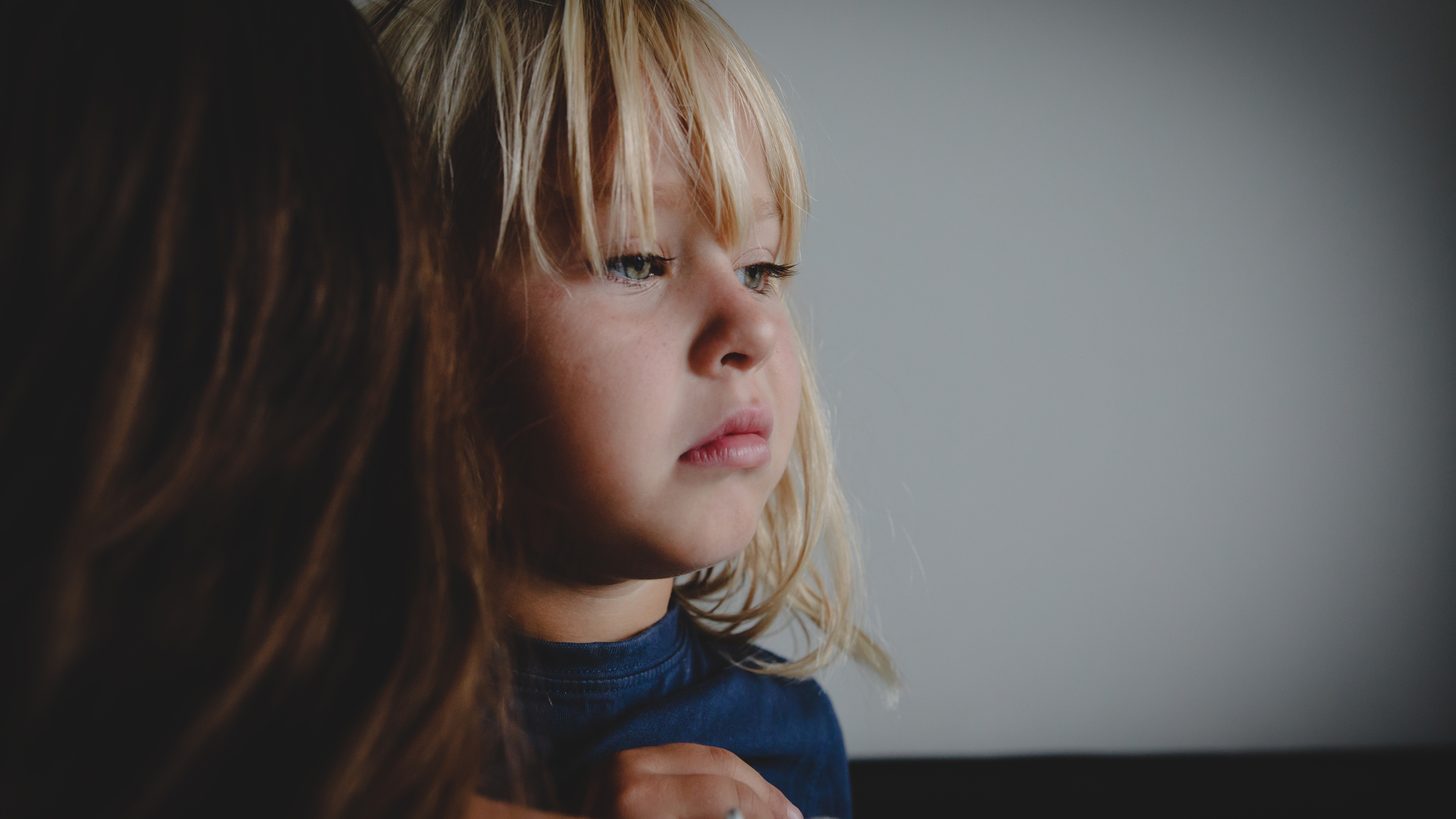 A sad child with her mother