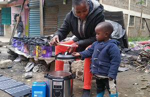 A man cooking with an electric cooker. 