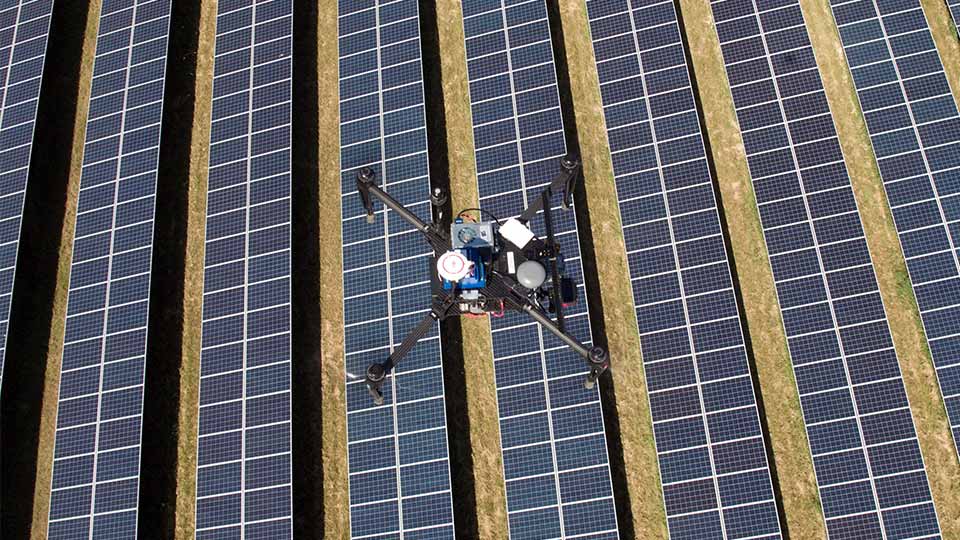 Close up of a drone flying over a field. Image courtesy of Above. 

