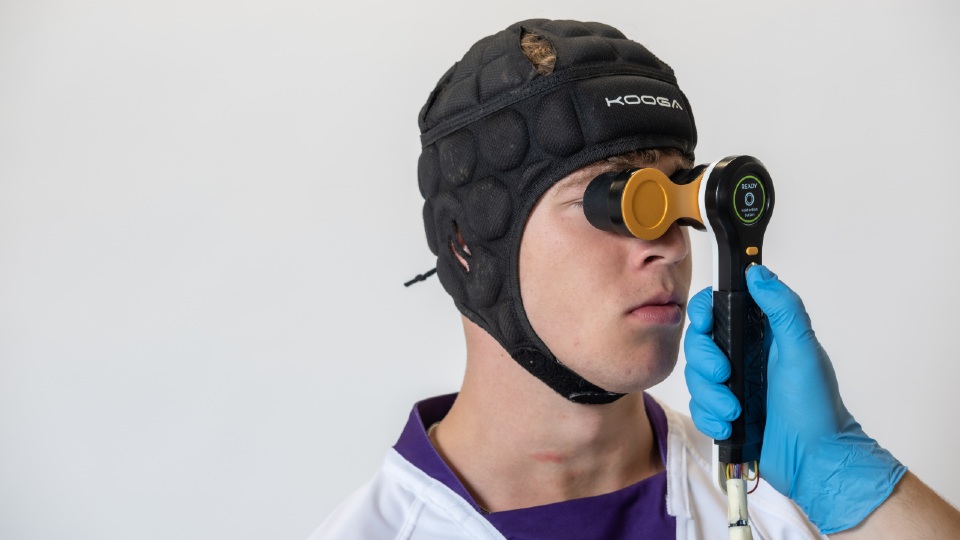 CONTACT being held up to a rugby player's face 