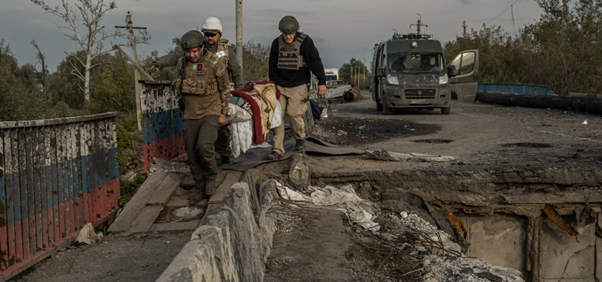 person being rescued by stretcher in war torn Ukraine