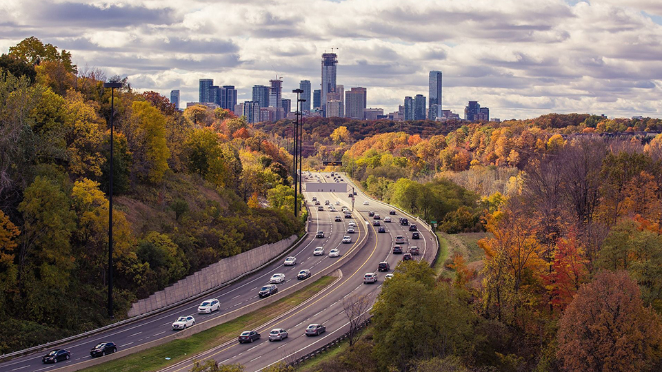 photo of a busy highway with backdrop of city and buildings