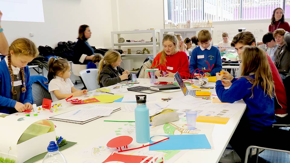 Students making models with St Bart's pupils. 