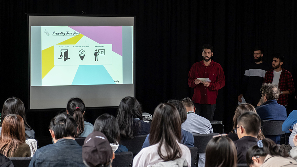 Photo of students presenting ideas to Fearon Hall Community Centre