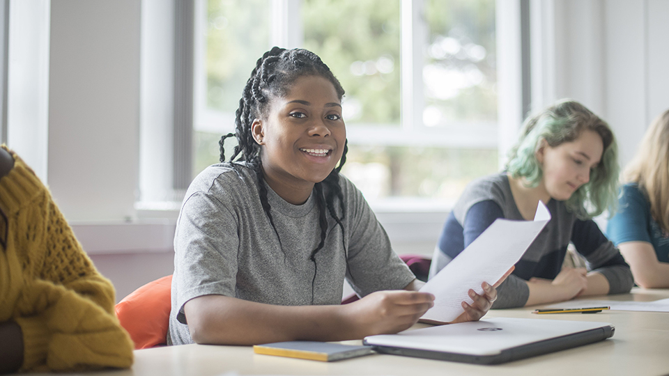 photo of Loughborough student sat at table smiling