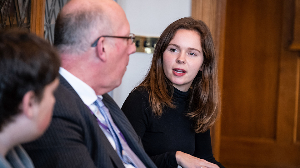 photo of Bob Allison speaking with one of the LU Arts scholarship students, Hannah, at the presentation event