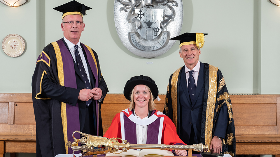 photo of Mel Marshall at graduation with Seb Coe and Bob Allison