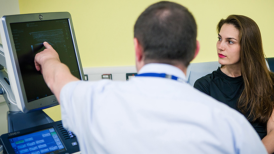 photo of NCSEM staff member and patient both look at a computer screen