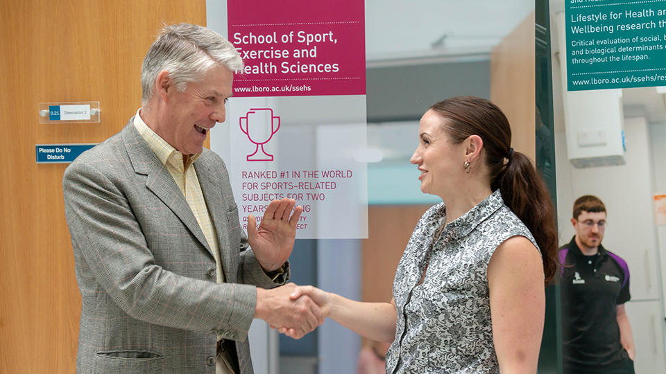 Dr Florence Kinnafick shaking hands with a representative of St Andrew's Healthcare