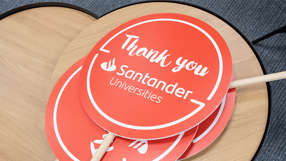 photo of red lollipop signs that say 'Thank you Santander Universities' in white writing