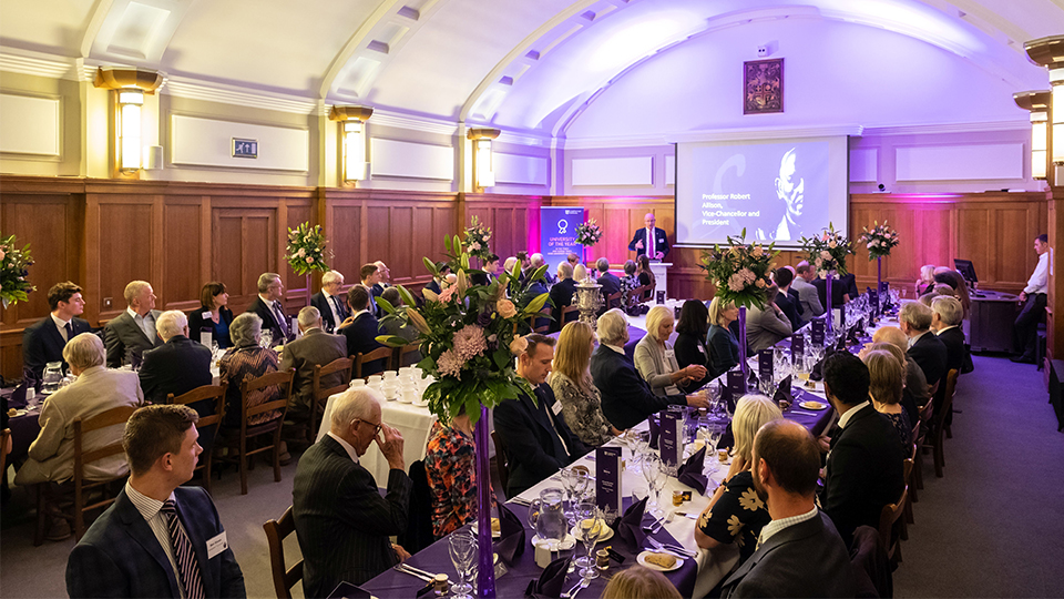 photo of Schofield Society members sat along two tables in Hazlerigg's Council Chamber with VC Bob presenting at the heads of the table