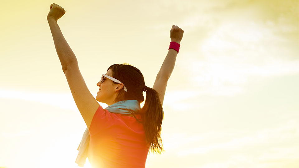 happy woman with her arms in the air 