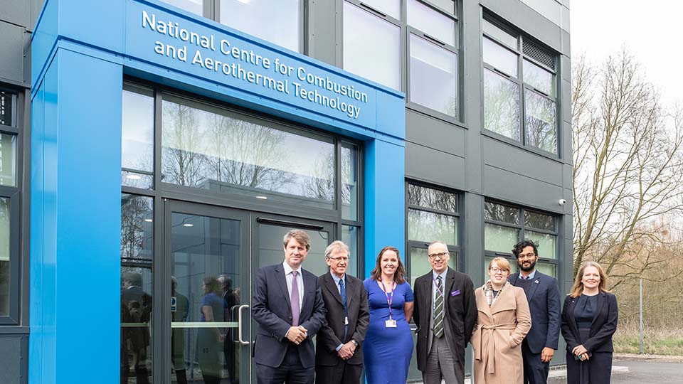 Minister with University staff and LSU reps outside NCCAT building