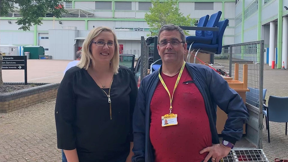 Two Falcon members of staff in front of the furniture they collected 