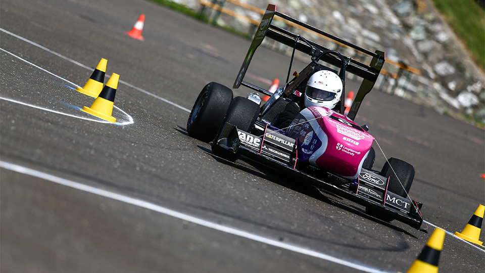 Photo of car in motion on racetrack 