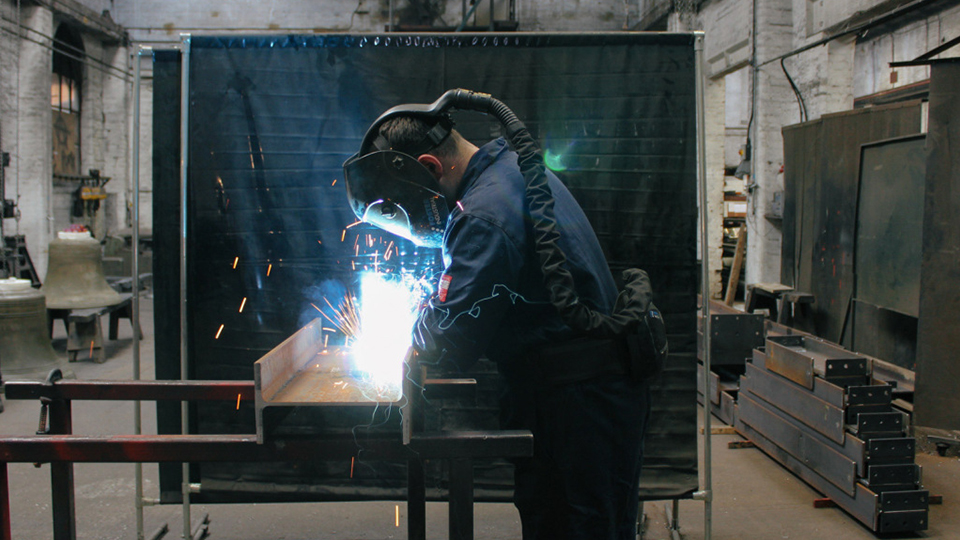 Photo by Lucy Moult showing an employee working at John Taylor Bell Foundry. 