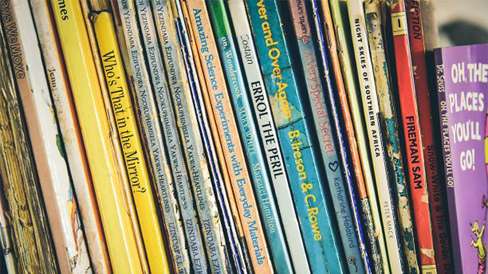 Close-up image of a collection of books on a shelf