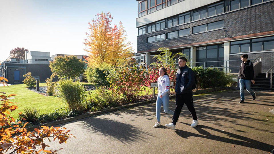 Photo of two students walking on campus