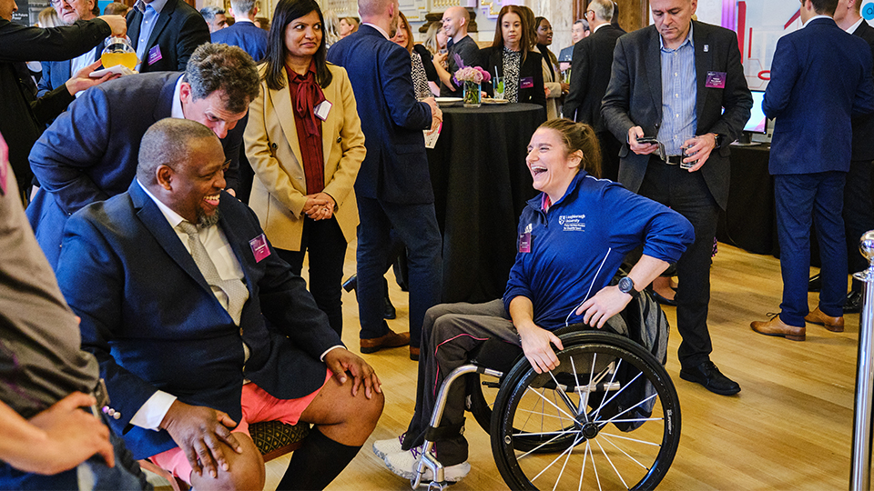 Photo of guests laughing together at the launch event of the University Strategy