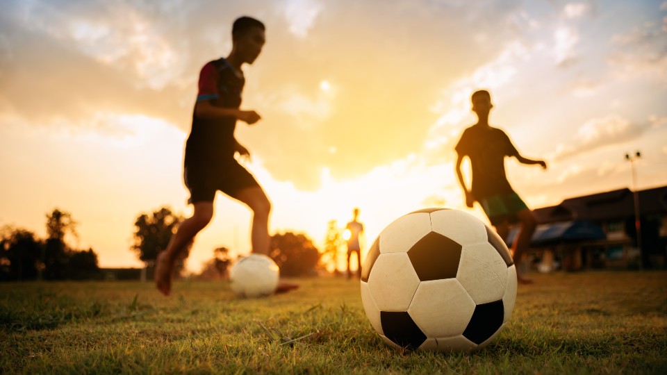 footballers playing on a pitch