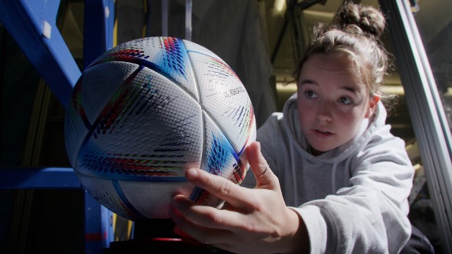 a researcher holding an adidas ball