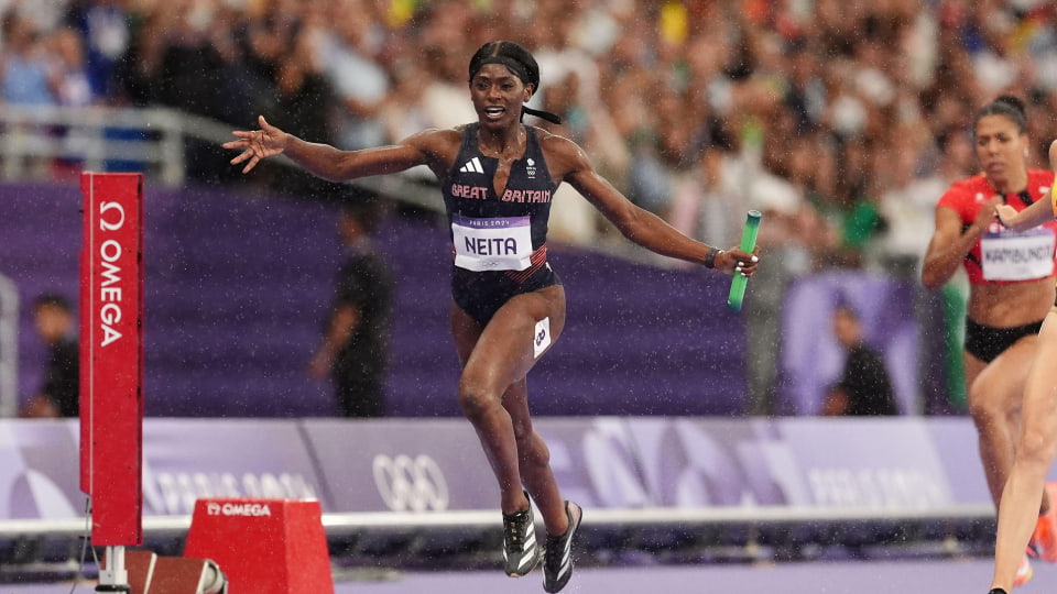 athlete Daryll Neita crosses the finish line in the women's 4x100m relay