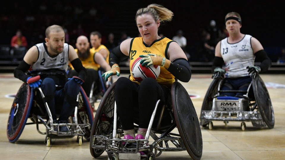 a female wheelchair rugby player playing in a match