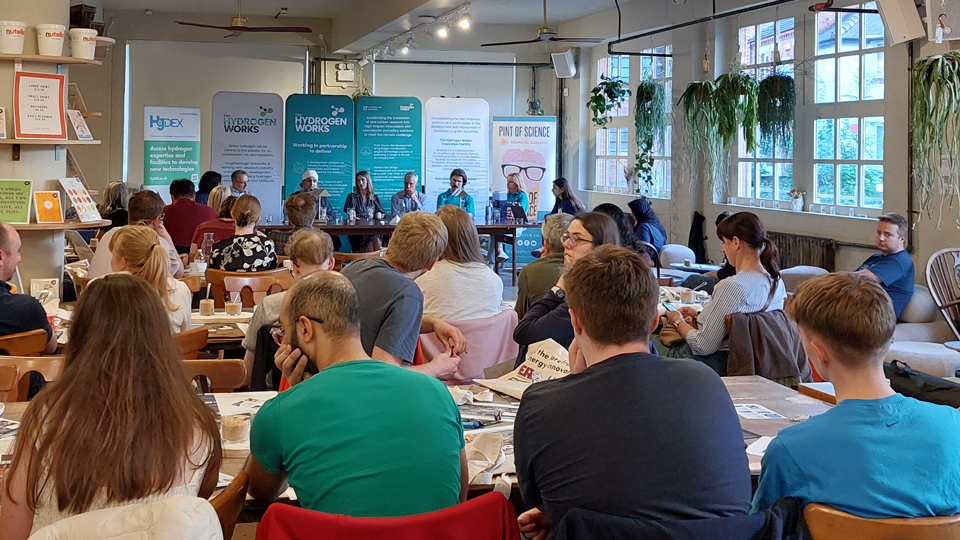 From the back of the room, looking over the audience toward the Pint of Science panel