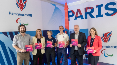 colleagues holding Loughborough's new para sport strategy