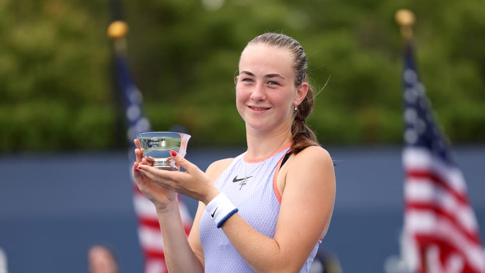 Tennis player Mika Stojsavljevic  holds the US Open junior title aloft