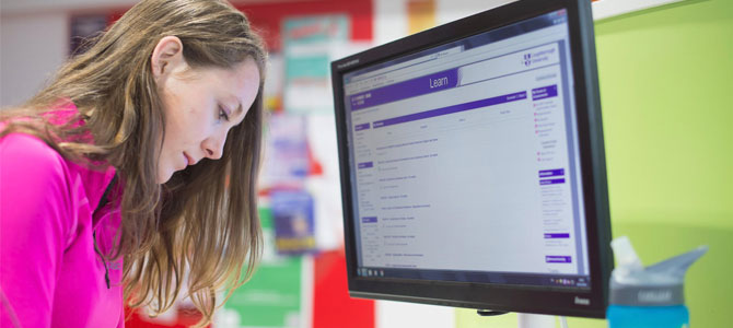 Student looking at the Learn VLE on a monitor in a learning pod