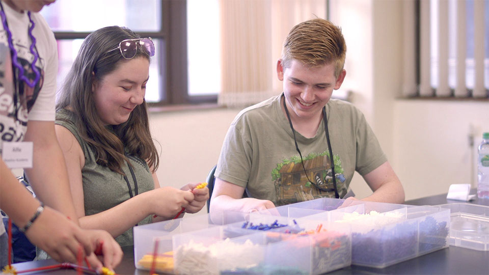 two young carers enjoy a workshop at explore more event