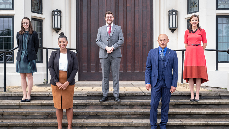 A photo of the team members of Legal Services stood outside Hazlerigg Building on the front steps