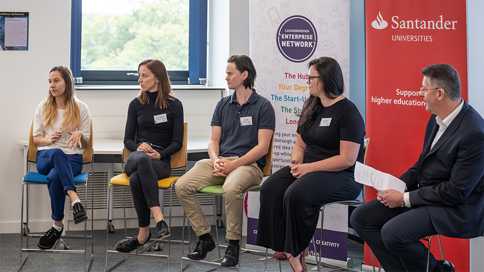 Photo of various alumni on a panel discussion about 'being your best self' as part of the Santander agreement