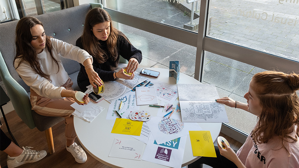 Photo of students engaged in creative activities held as part of World Mental Health Day programme